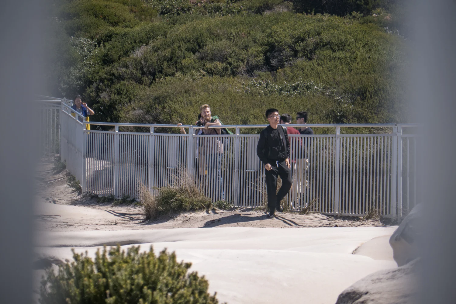 A larger group of visitors arrive and jump into the restricted area. Not before posing for selfies with the danger signs.