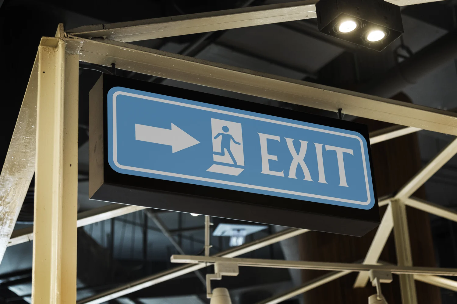 Blue Exit sign with an arrow and running figure.