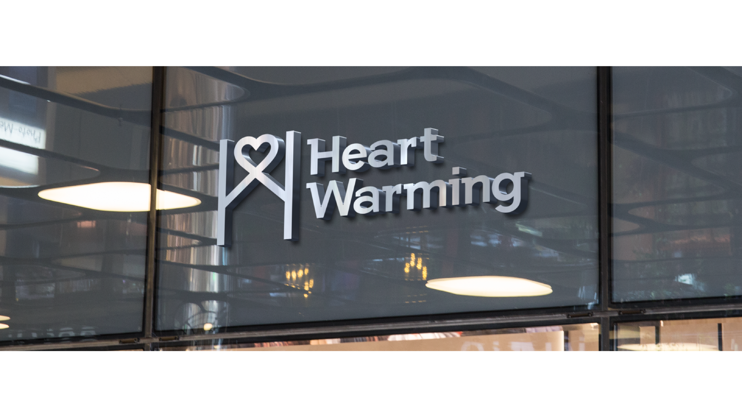 Heart Warming logo on a frosted glass wall in an office.