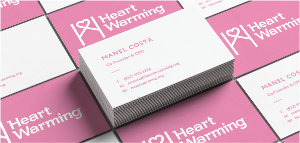 Pink and white business cards with the Heart Warming logo.
