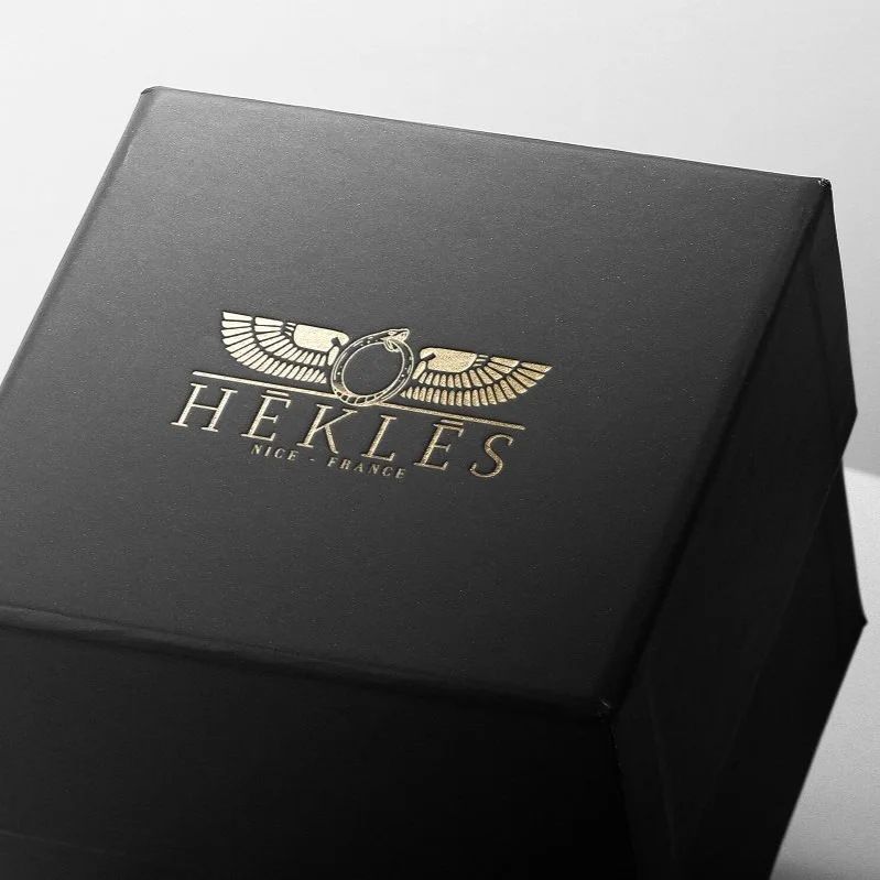 Black jewellery box with the logo in gold.