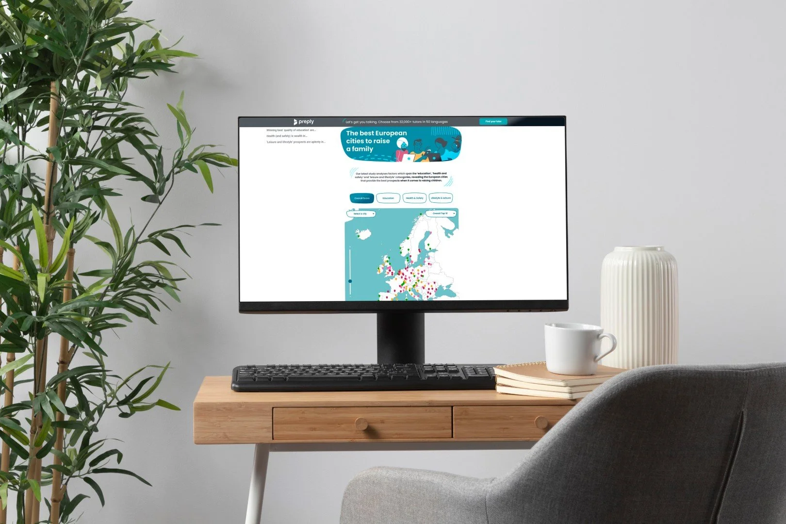 Desktop mockup on a wooden desk showing the Preply interactive map of Europe’s best cities for raising a family.
