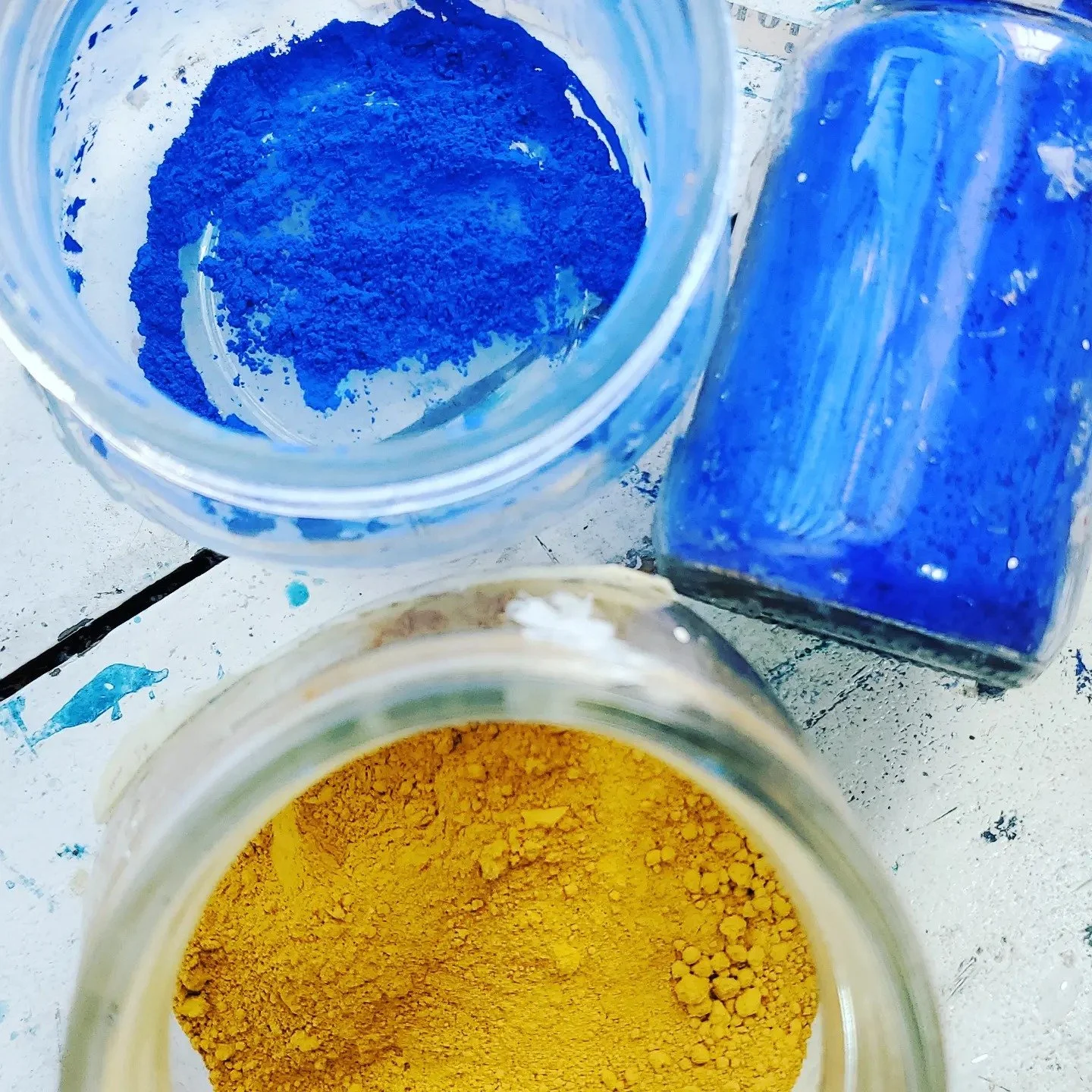 Close-up of raw blue and yellow dry pure pigments used for hand-mixed paint.