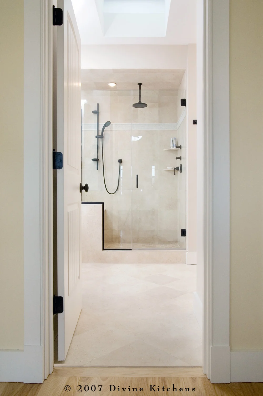 Beach inspired master bathroom with bronze oiled accessories, white shaker cabinets, pothos greenery, and starfish decor