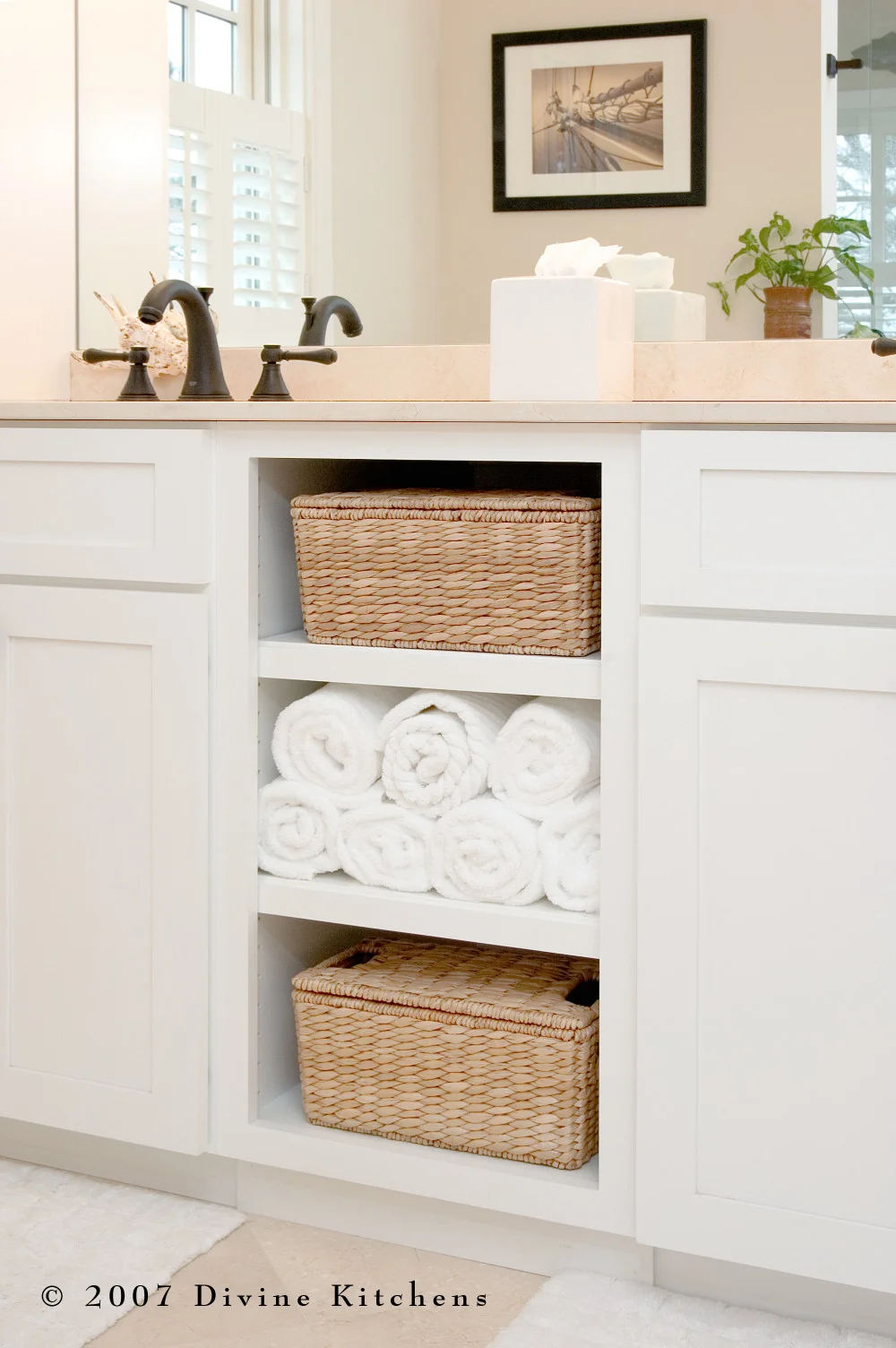 Beach inspired master bathroom with bronze oiled accessories, white shaker cabinets, pothos greenery, and starfish decor