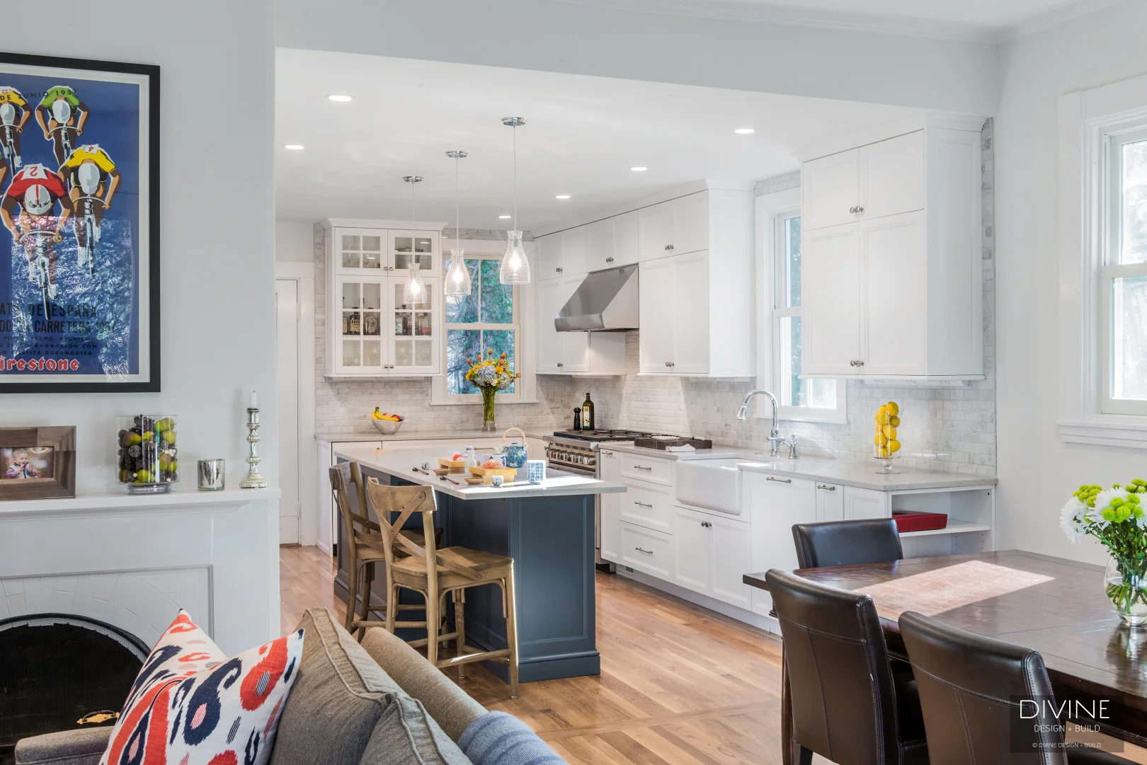 white transitional kitchen with white shaker cabinets and brushed nickel accessories. cambria calacatta island countertop with blue cabinetry. Wolf appliances. mosaic subway tile backsplash