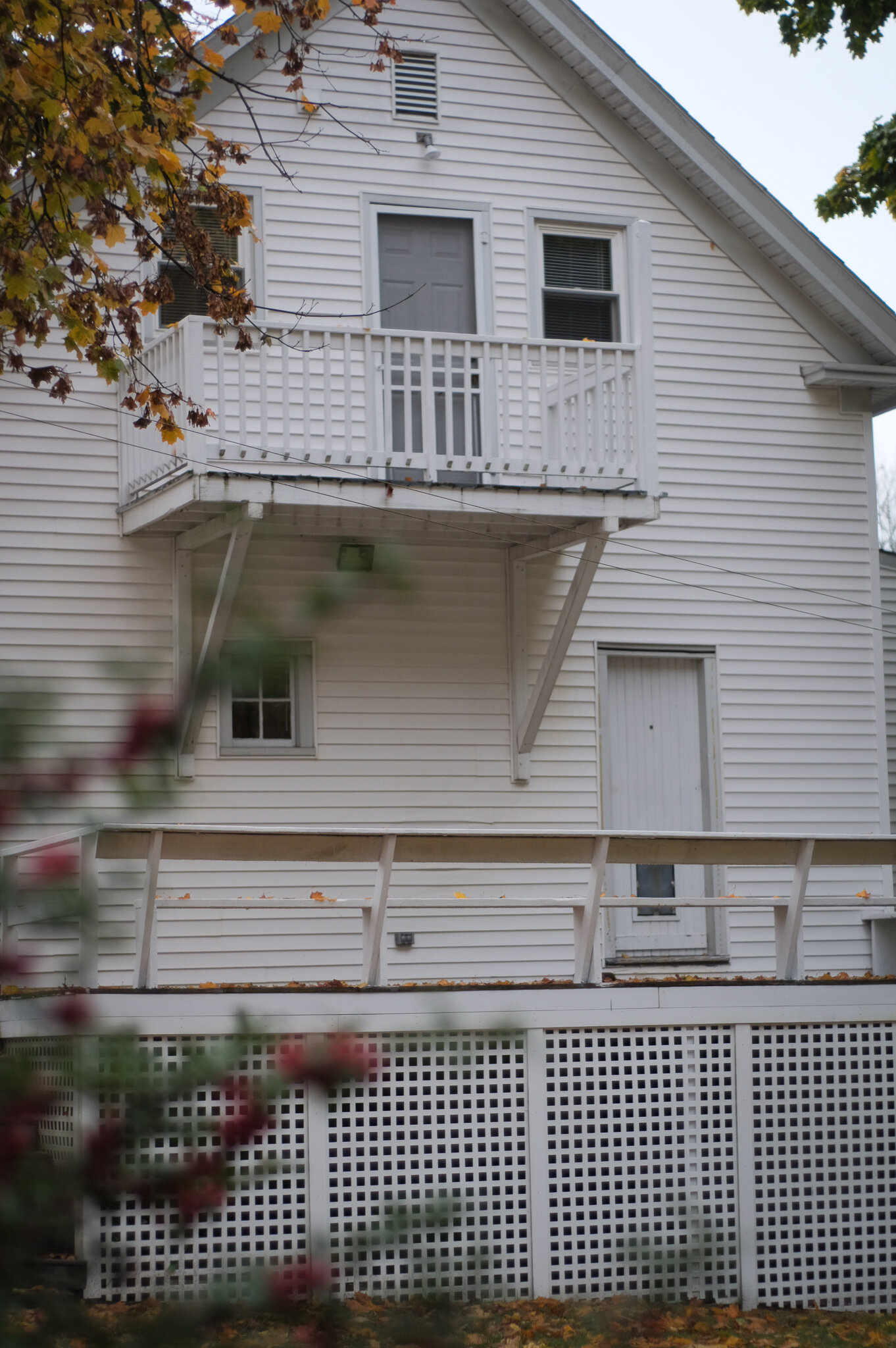Bedroom has balcony attached that looks over large back porch