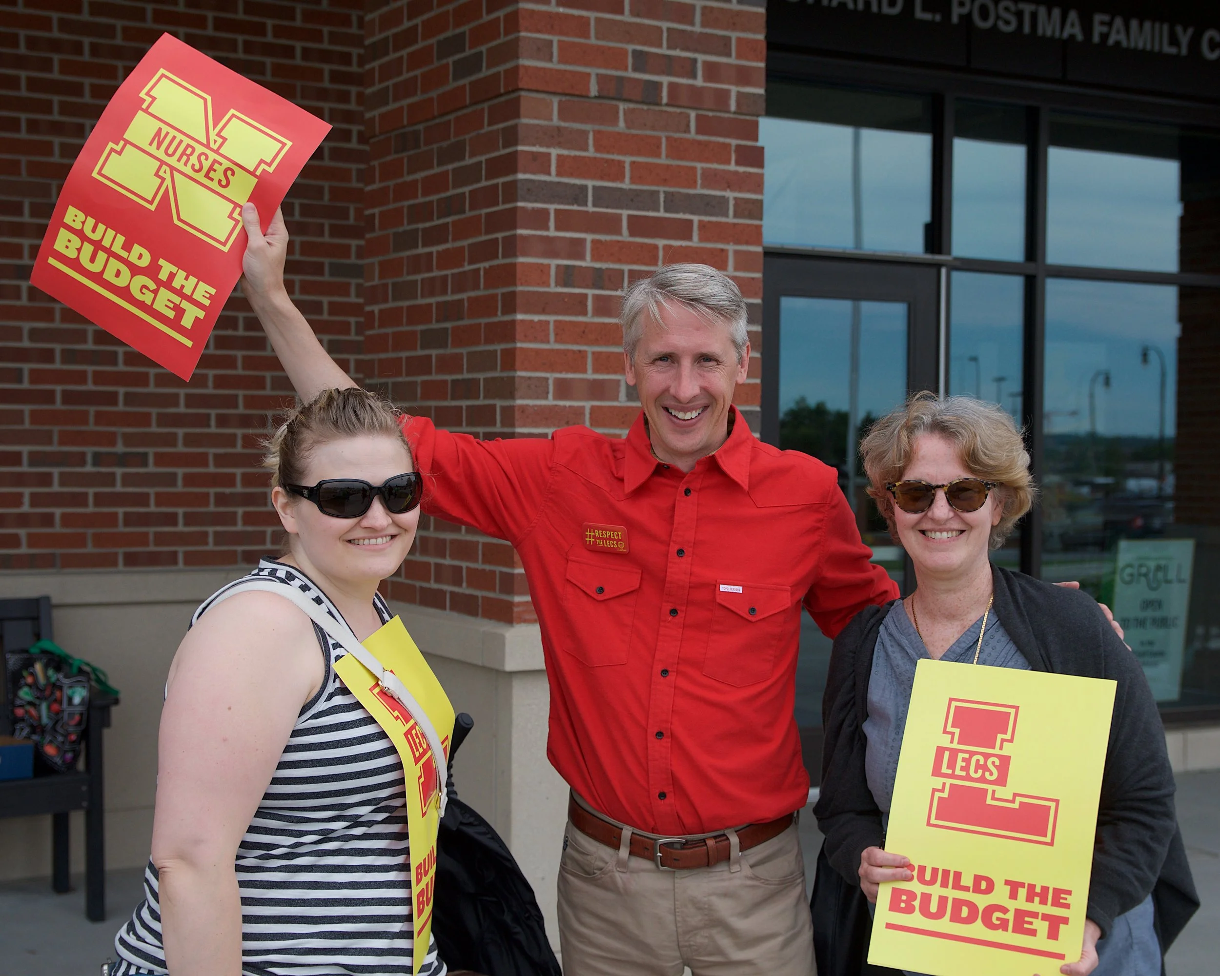 Lecturers Anita (Flint), Paul (Ann Arbor), and Debbie (Ann Arbor) at a University Board of Regents’ Meeting in Summer 2018, demonstrating solidarity between UM Lecturers and UM nurses