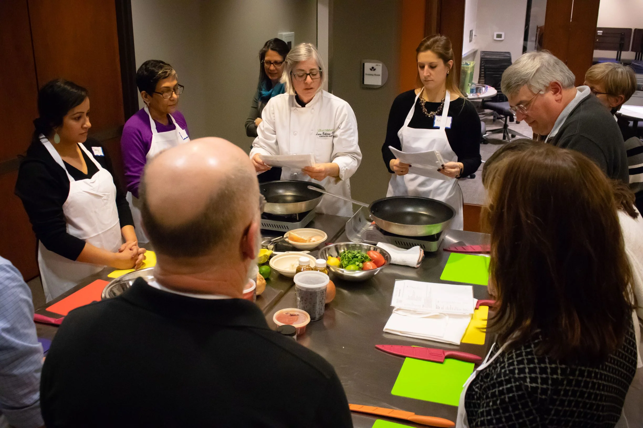 PLA Alumni gather around the chef’s table, awaiting instructions from Local Matters chef Laura Robertson-Boyd.