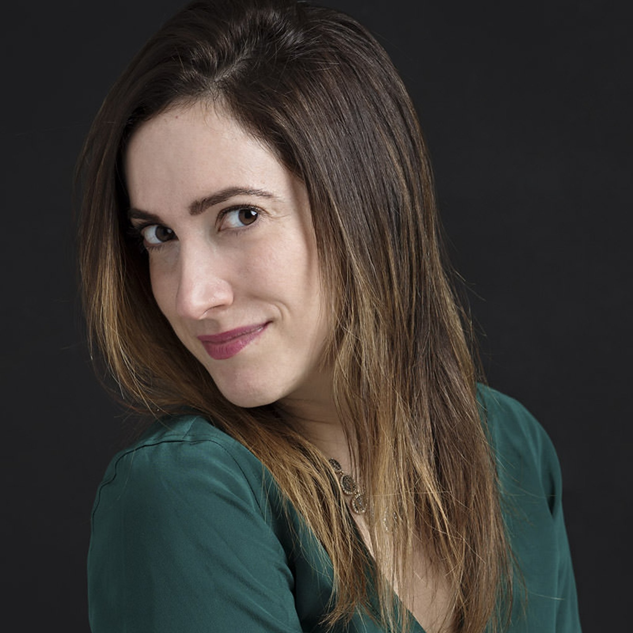 self portrait of a photographer wearing a green top with a slight smile at the camera in bergen county nj