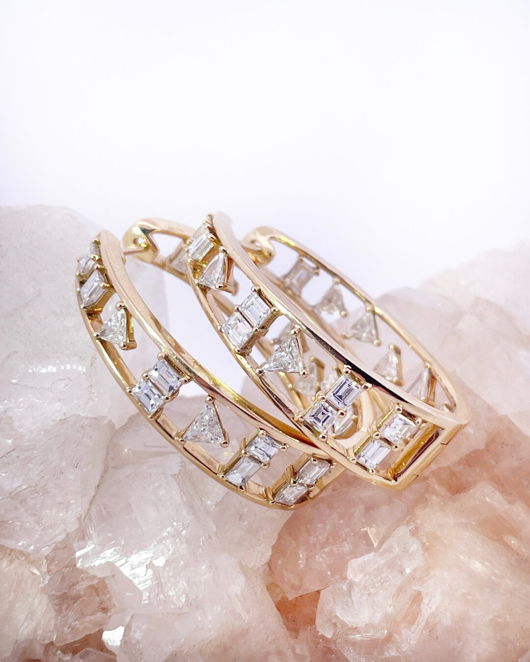 These unique hoop earrings are a perfect blend of luxurious design and avant-garde style. Featuring mixed shape diamonds set one and two at a time, these yellow gold beauties are set to stun. Equal parts elegant and eye-catching, these diamond hoops 