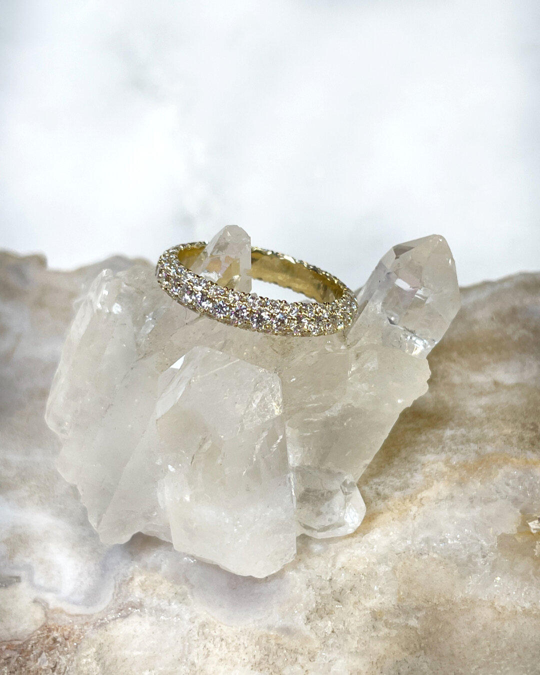 As artistic in design as it is luxe, this intricate eternity ring features three layered rows of diamonds. A stunning ring like this can be worn as a touch of everyday elegance, or it can worn as a wedding ring. Set in yellow gold this gorgeous ring 