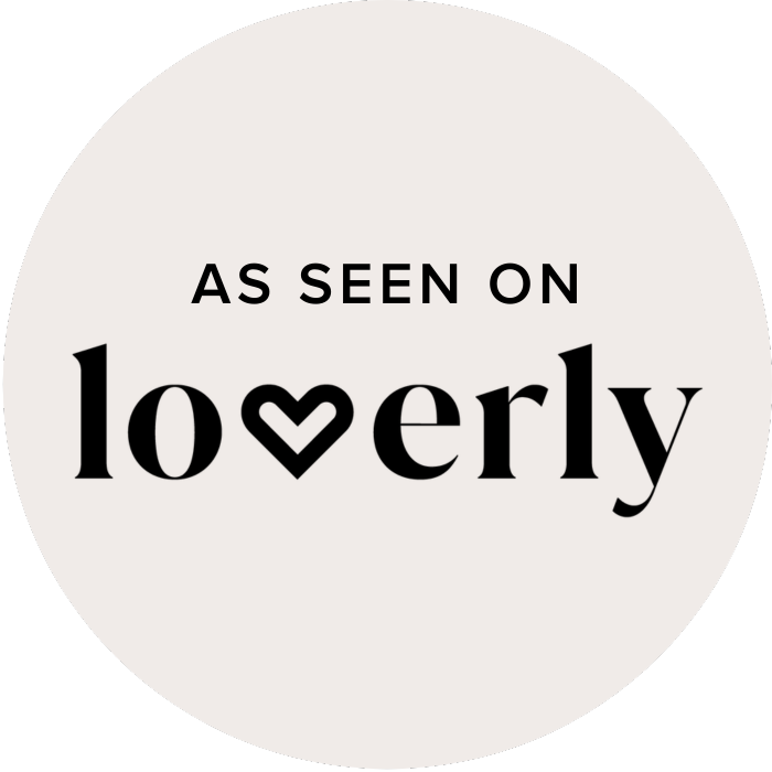 Black text on a gray circular background reads 'As seen on loverly' with a heart shape inside the letter 'v'.