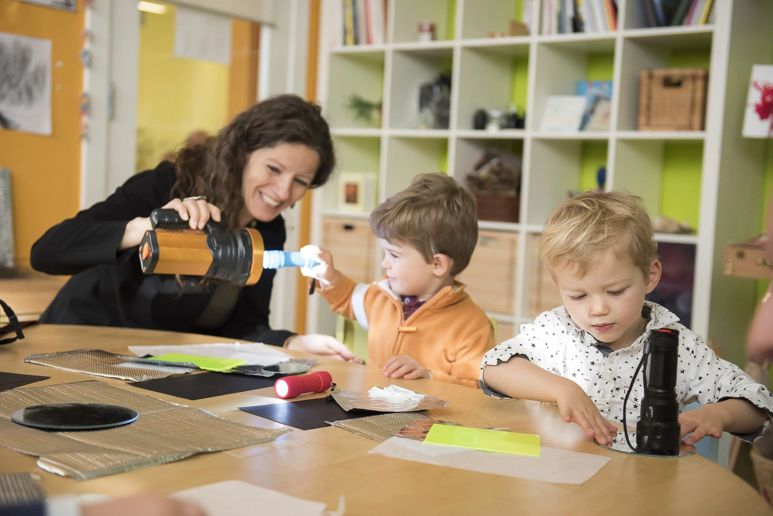 Serena Morelli, our Prek Atelierista, works alongside some students exploring with light!