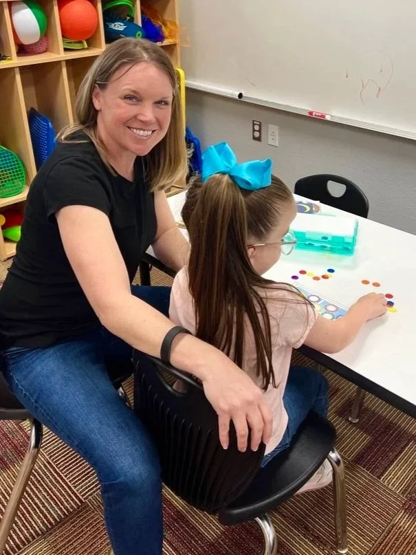 School based occupational therapist working with student.