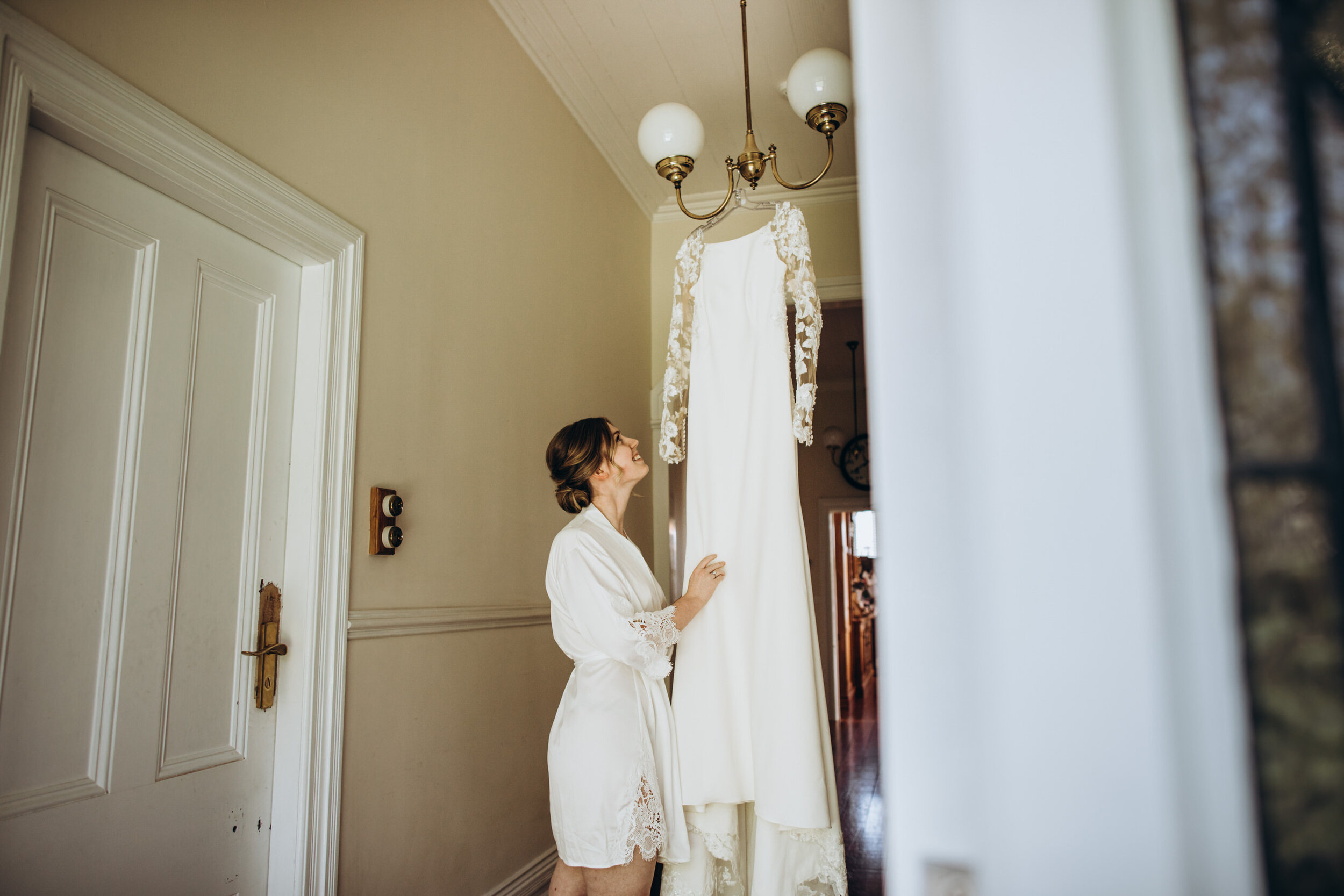 Bride getting dressed photos | Almaj Bridal wedding dress 