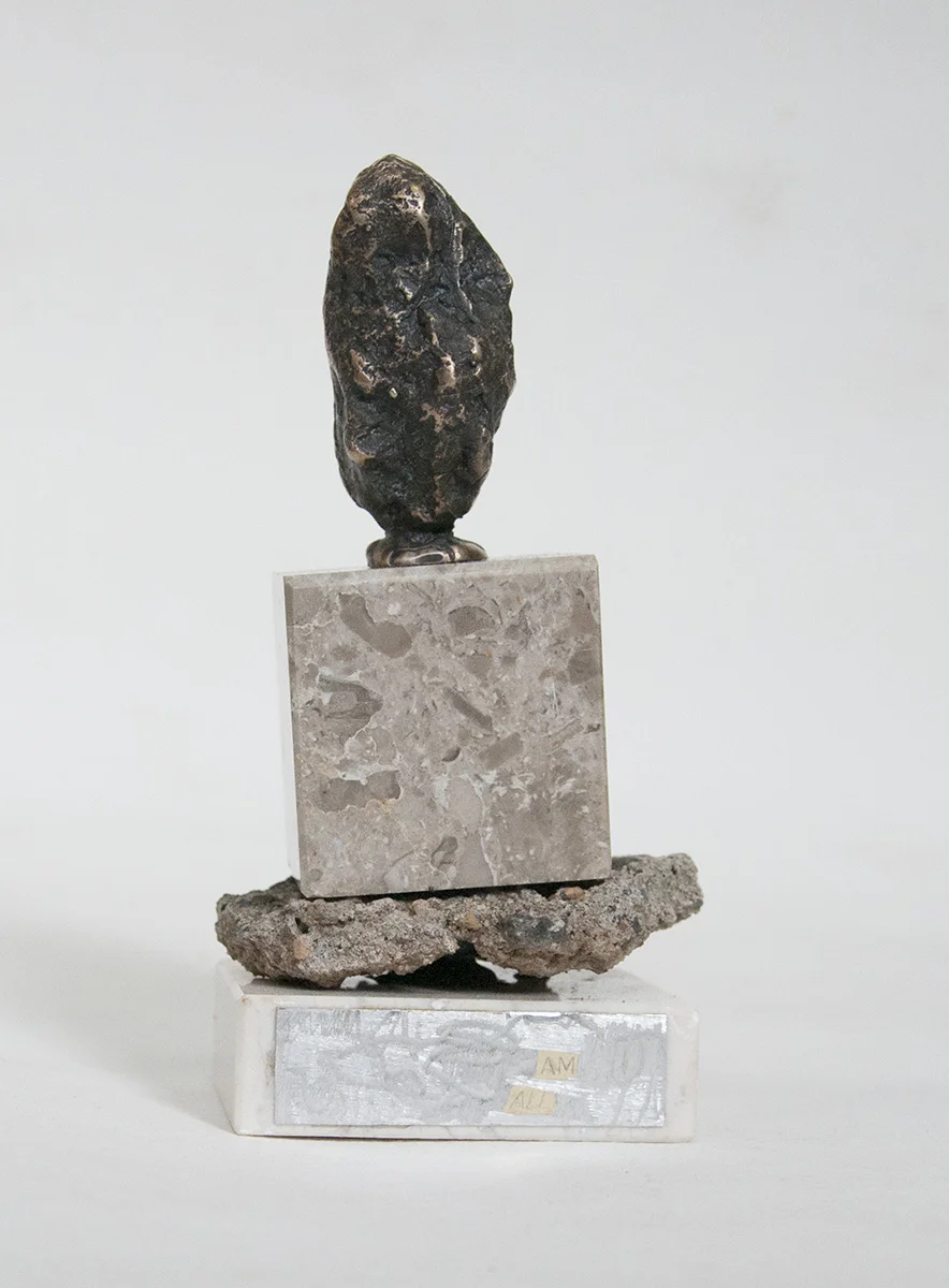  Rebecca Gallo,  Small wins 5 , 2018, granite trophy base and centre block, redacted engraving, concrete fragment, cast bronze, 10 x 18 x 10 cm   