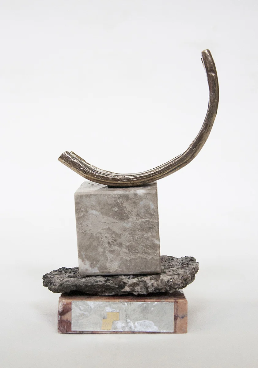  Rebecca Gallo,  Small wins 6 , 2018, granite trophy base and centre block, redacted engraving, granite fragment, cast bronze, 12 x 20 x 10 cm 