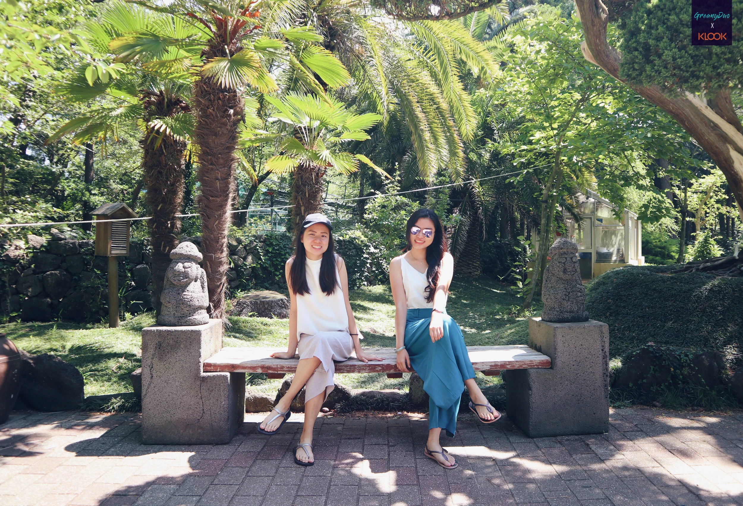 jenny and tina posting on a bench at สวนฮัลลิม (Hallim Park)