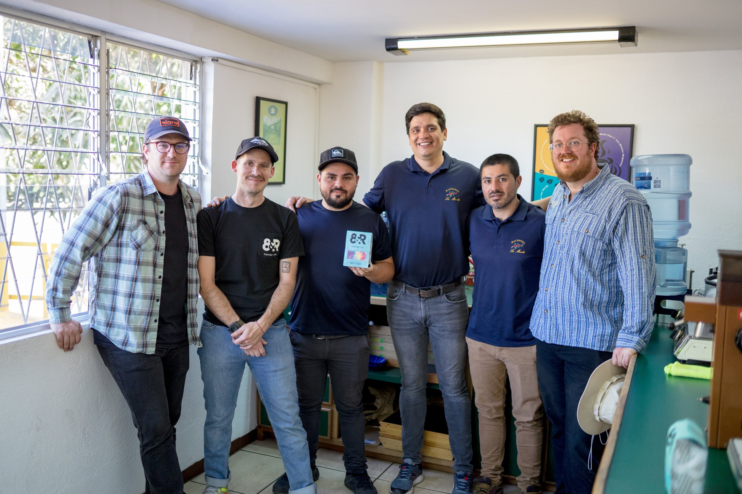  8th &amp; Roast head roaster Ty Telgenhof, left, and Max Oden,  second from left, stand with the amazing processing and QC team at La Minita in their lab.  