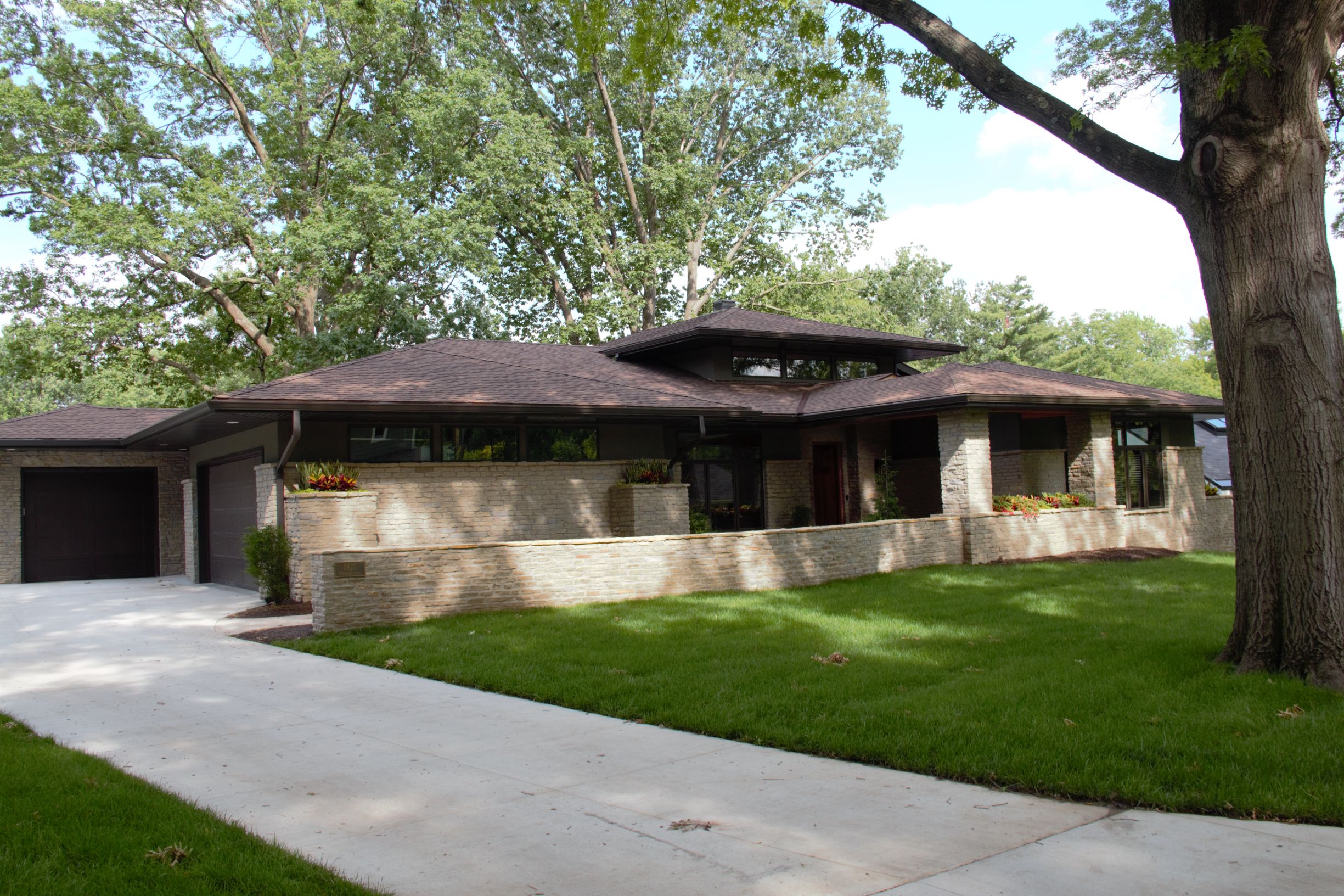 Side entry for the double stall garage and the single garage set back to minimize their visual impact.