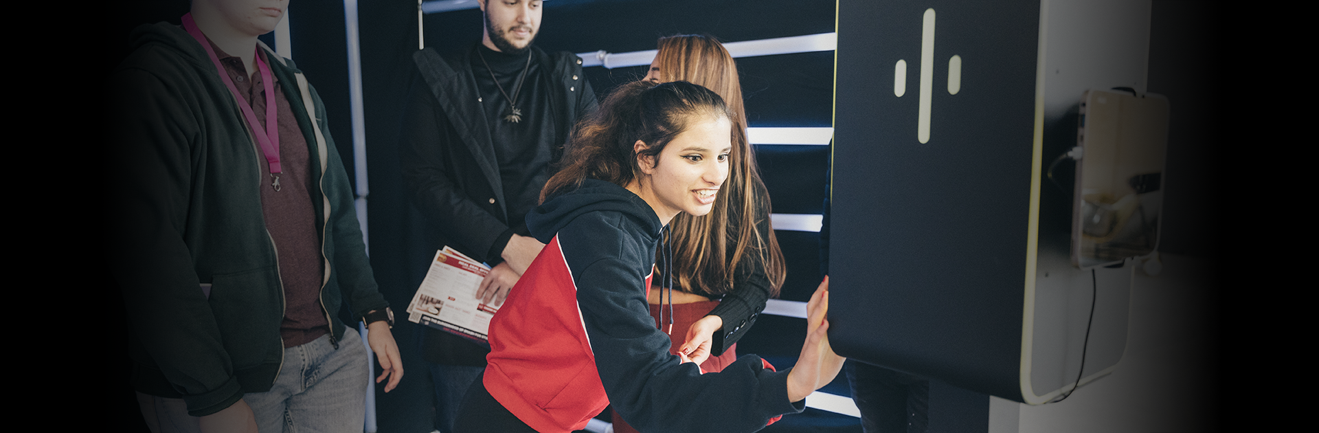 Students interacting with a branded activation unit at a university freshers fair