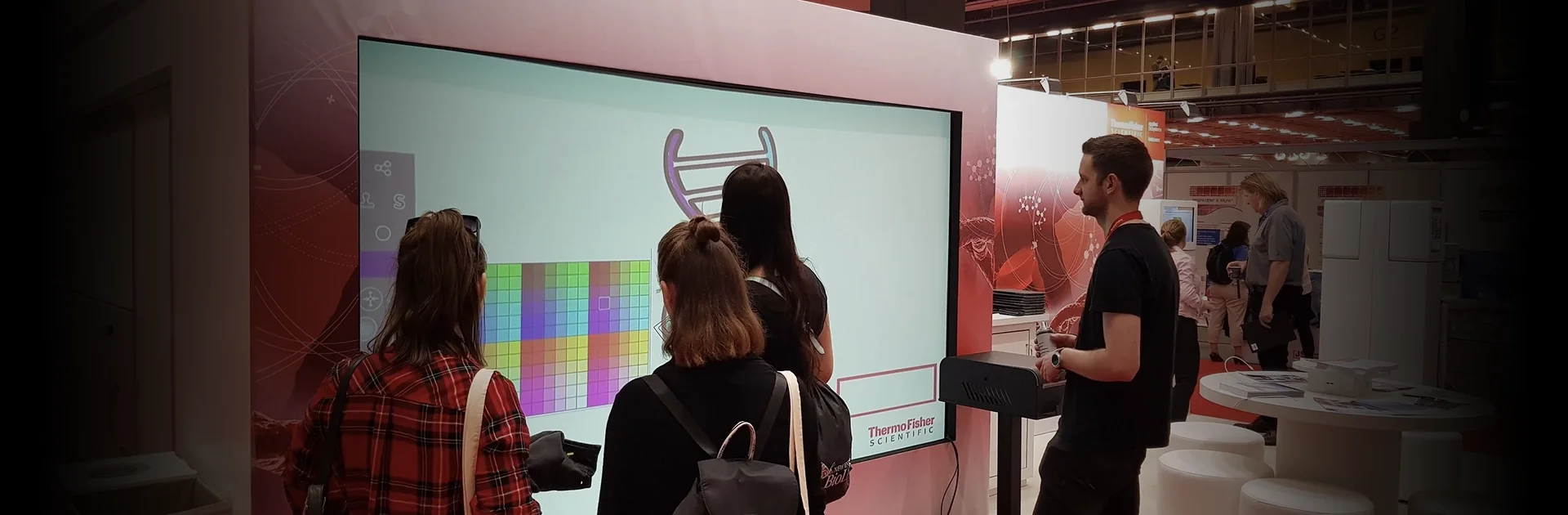 Interactive touchscreen activation at a trade show for Thermo Fisher Scientific — branded digital wall experience by Social Jungle