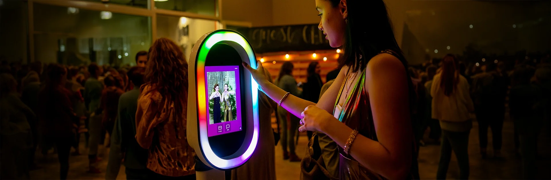 Branded photo booth hire at a live event — guest using the Allegra open-air booth by Social Jungle