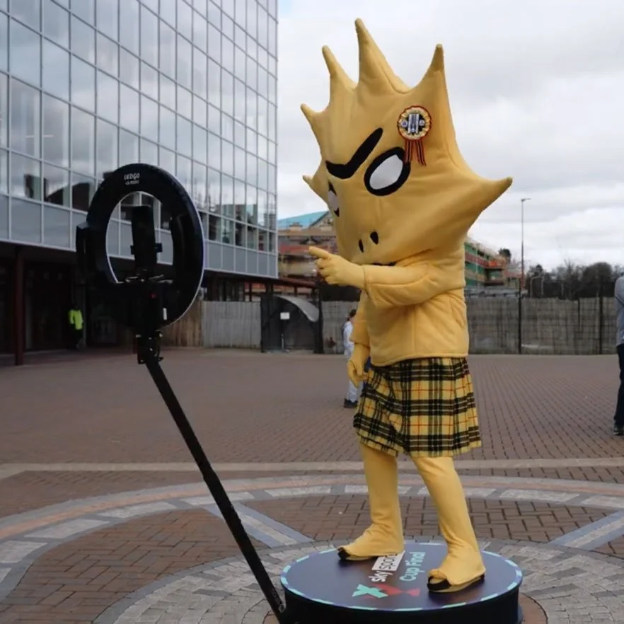 Fan on the Social Jungle 360 booth capturing a branded video at a live event