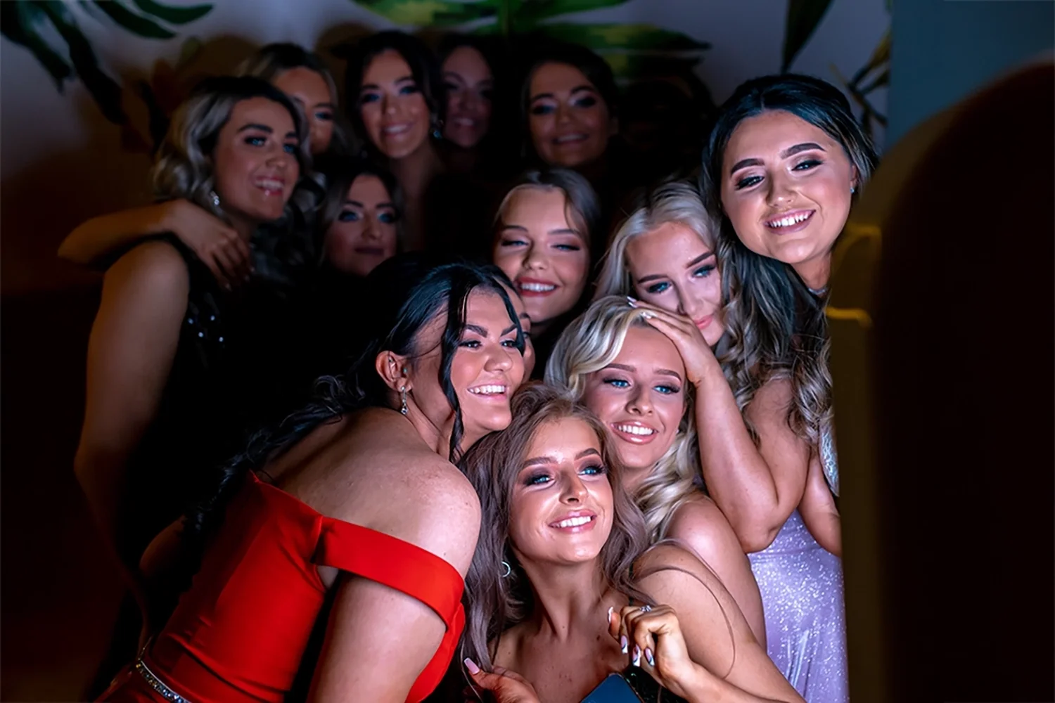 Large group of guests in evening wear crowding into a photo booth at a Glasgow event — photo booth hire by Social Jungle