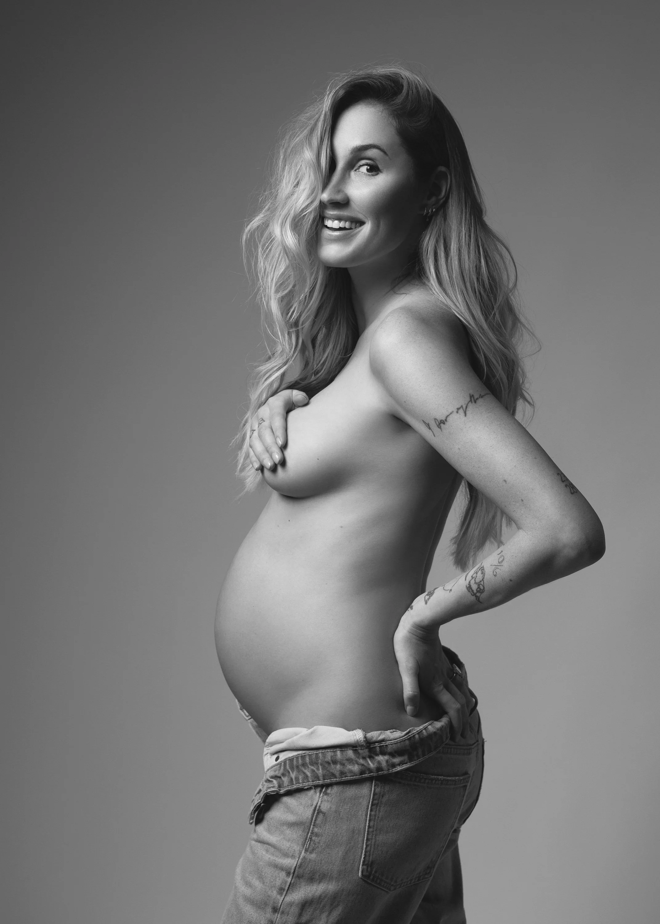 Black and white semi-nude maternity photography by Nemi Miller in her London studio.