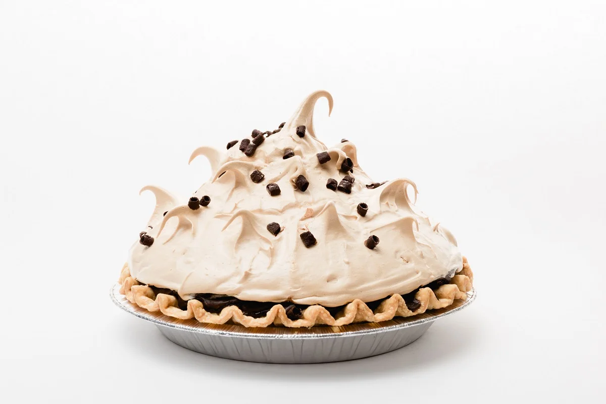 Chocolate pie with meringue peaks and chocolate chips
