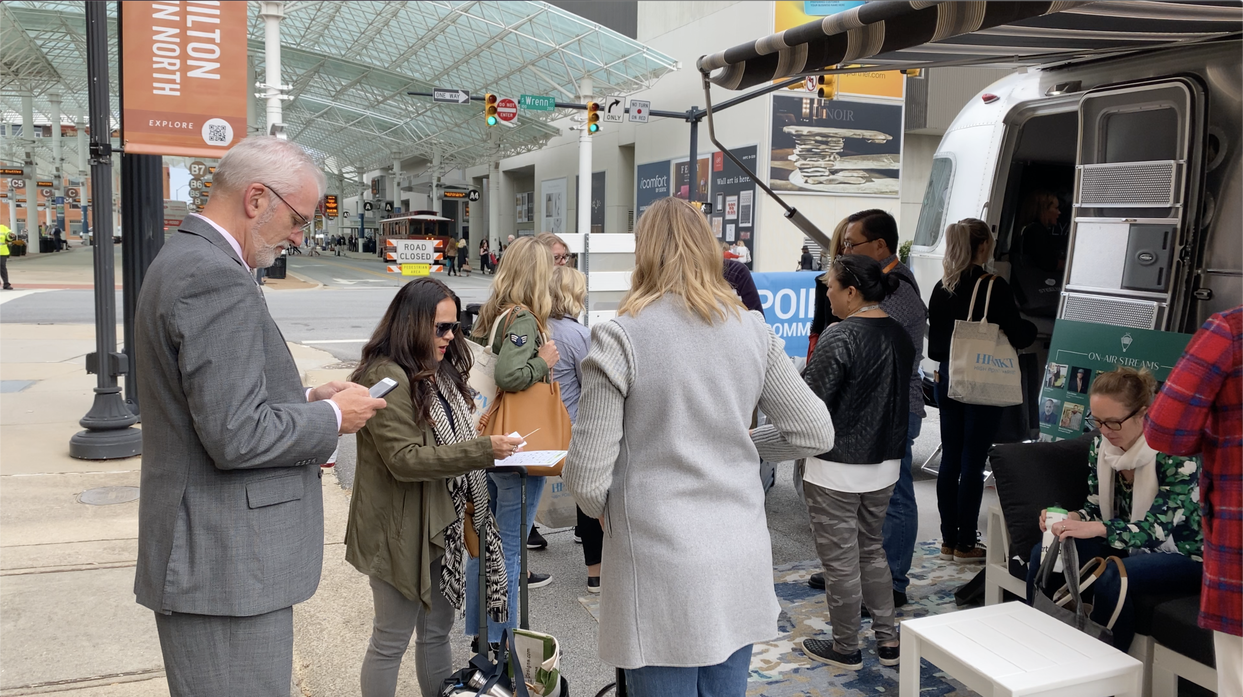 Jeanne Chung (middle left, in black jacket) and her entourage chatting outside the Airstream