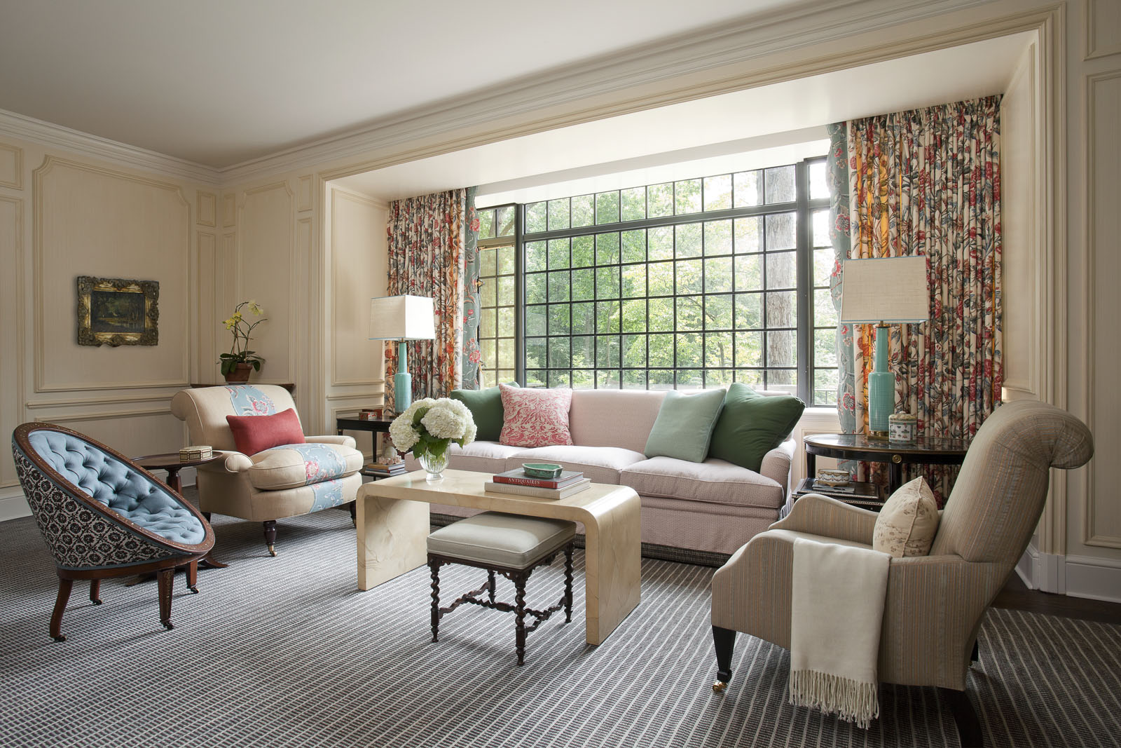  Isbell deconstructed a historic fabric from&nbsp;  Brunschwig &amp; Fils  &nbsp;and used sections to create the living room’s curtains and the appliqué detail on two chairs. The custom-made sofa is covered in a&nbsp;  Bennison  &nbsp;fabric and topp
