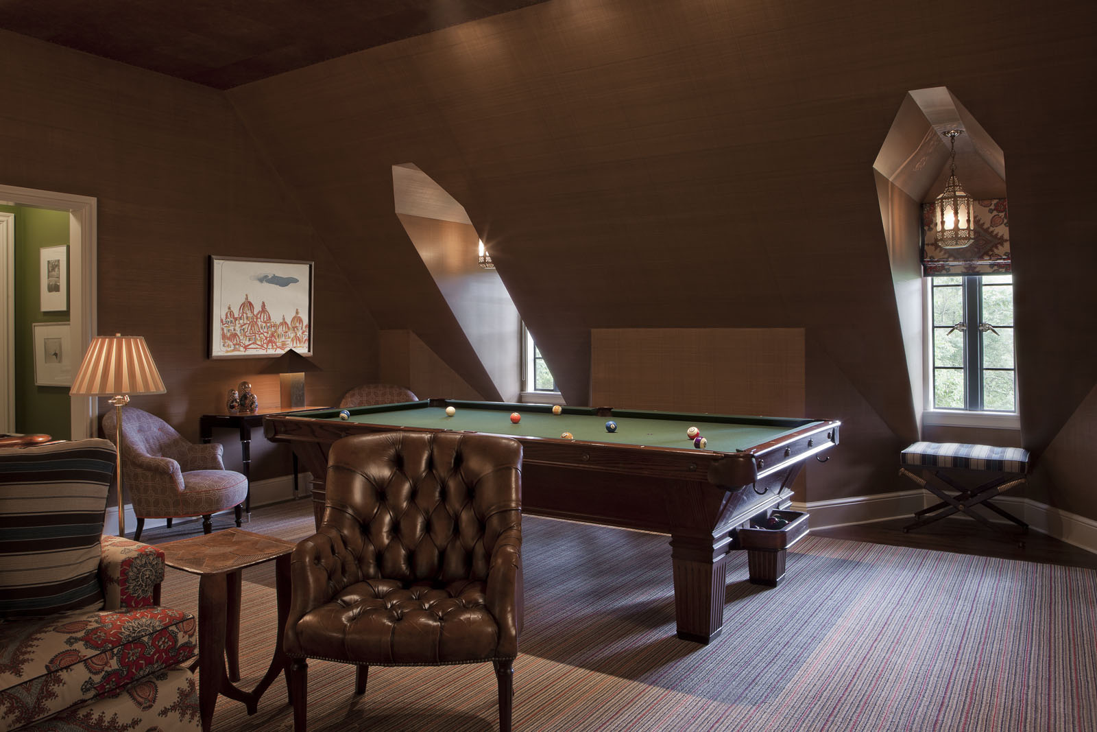  Part of the former staff quarters on the third floor was turned into a billiard room. The early-20th-century library chairs, vintage pool table, and leather-tiled ceiling add to the clubby atmosphere. 