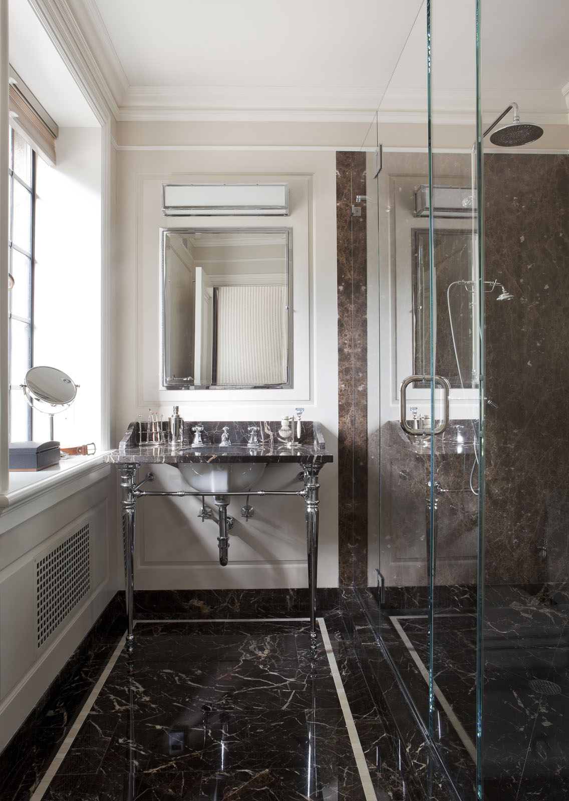  The husband’s sleek bath features a wall light by&nbsp;  Circa Lighting  , an&nbsp;  Urban Archaeology  &nbsp;vanity, and a mirror and shower fittings by&nbsp;  Lefroy Brooks  . 