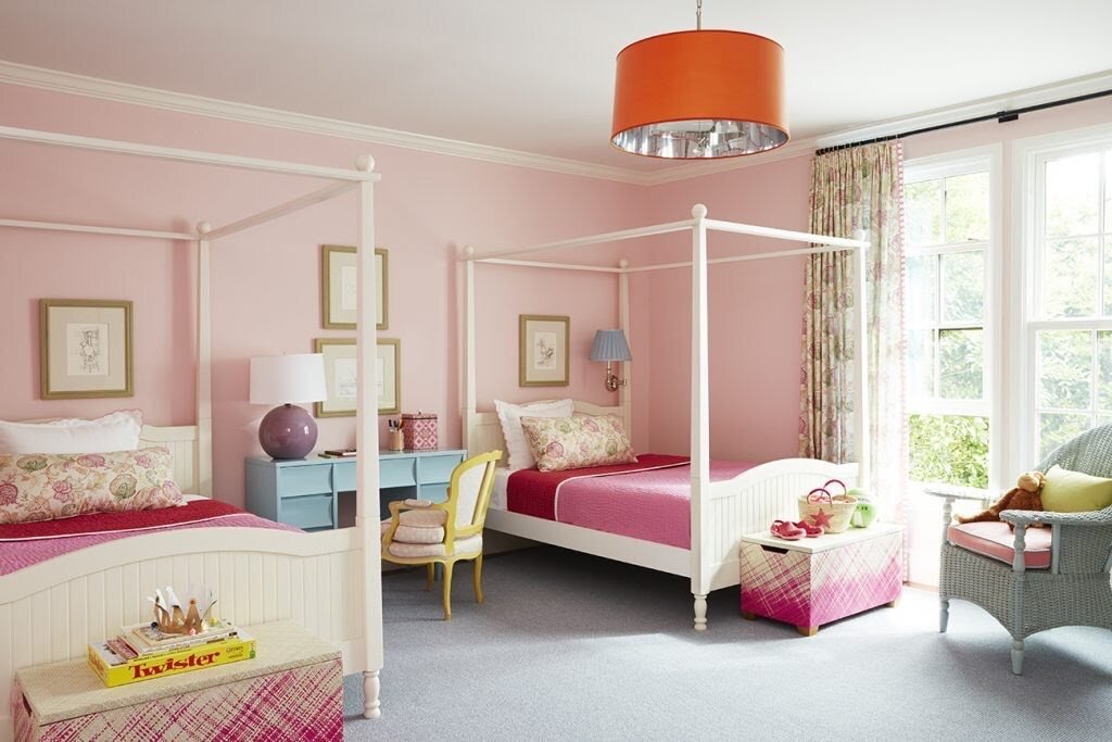  The clients’ daughters wanted a pink room, but Isbell added other colors — like the blue of the mid-20th-century desk and the orange hanging light — to make the decor easier to update as they get older, and possibly less enamored of pink. The desk i