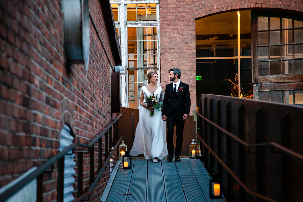 Bride and groom stand outside industrial wedding venue in western Massachusetts
