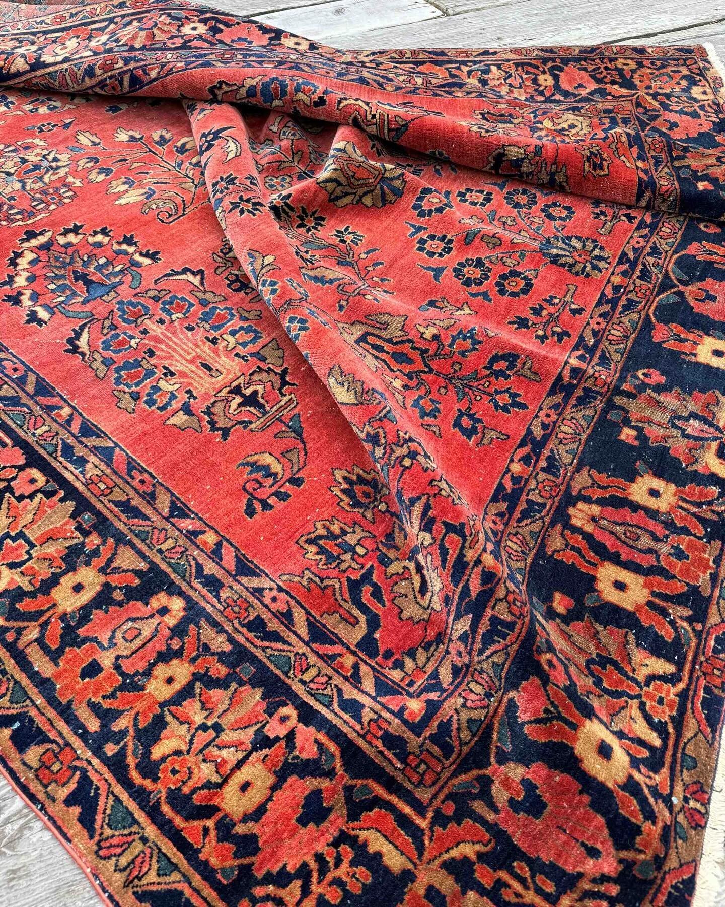Velvet-like wool and exotic stylized florals are the hallmarks of antique Persian Sarouk rugs. The stunning flame red ground on this gorgeous example is well suited to any interior craving a textured country home impression. It measures 8&rsquo;3&rdq