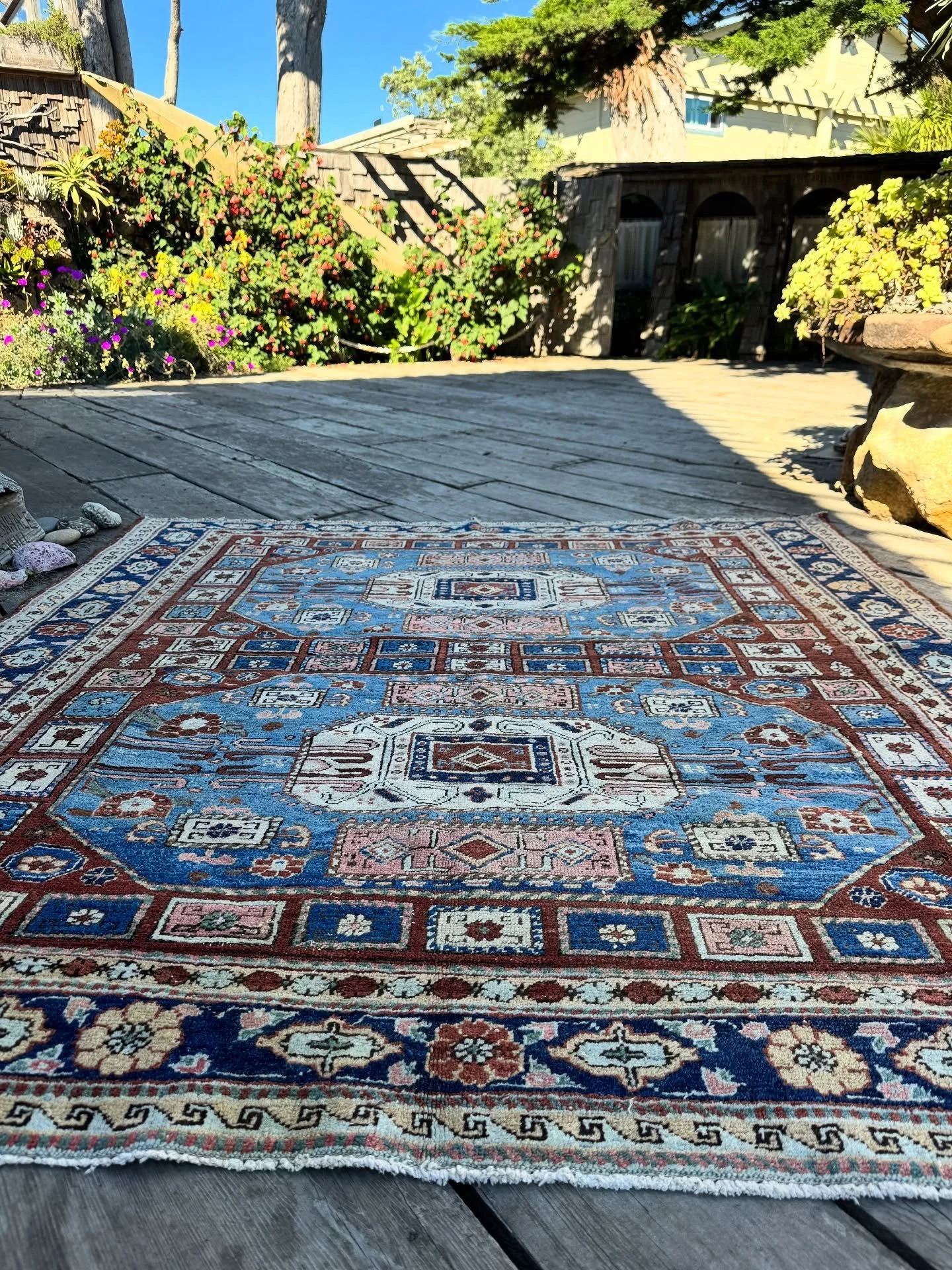 There is a rare group of antique rugs made in the Heriz local area that have designs borrowed from their northern neighbors in Armenia and Azerbaijan. This Heriz has a shimmering rendition of the octagonal Karachov motif. The naturally dyed colors of