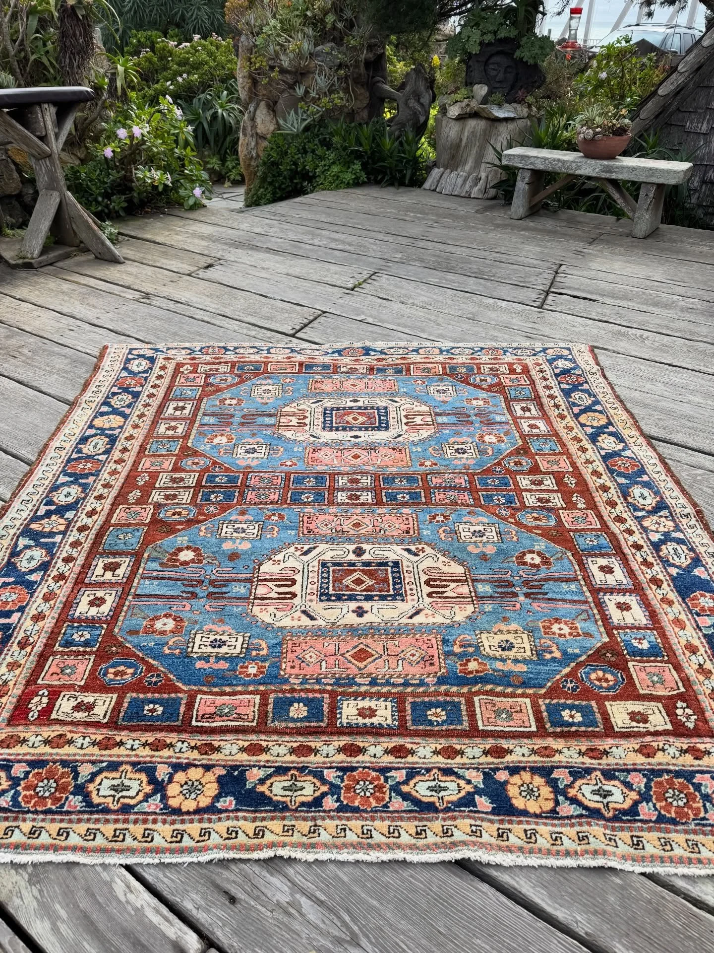 A rare antique Heriz with a Karachov Kazak design. The soft colors are 100% natural with many shades of blue, salmon, seafoam green, jade green, buff, and cream, on a gorgeous chestnut ground. Difficult to find squarish size of 6&rsquo;2&rdquo;x6&rsq