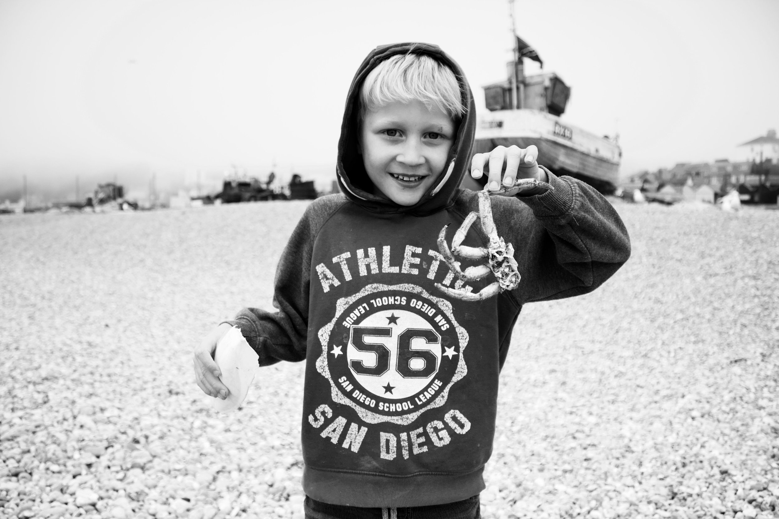 black and white photo of child on beach