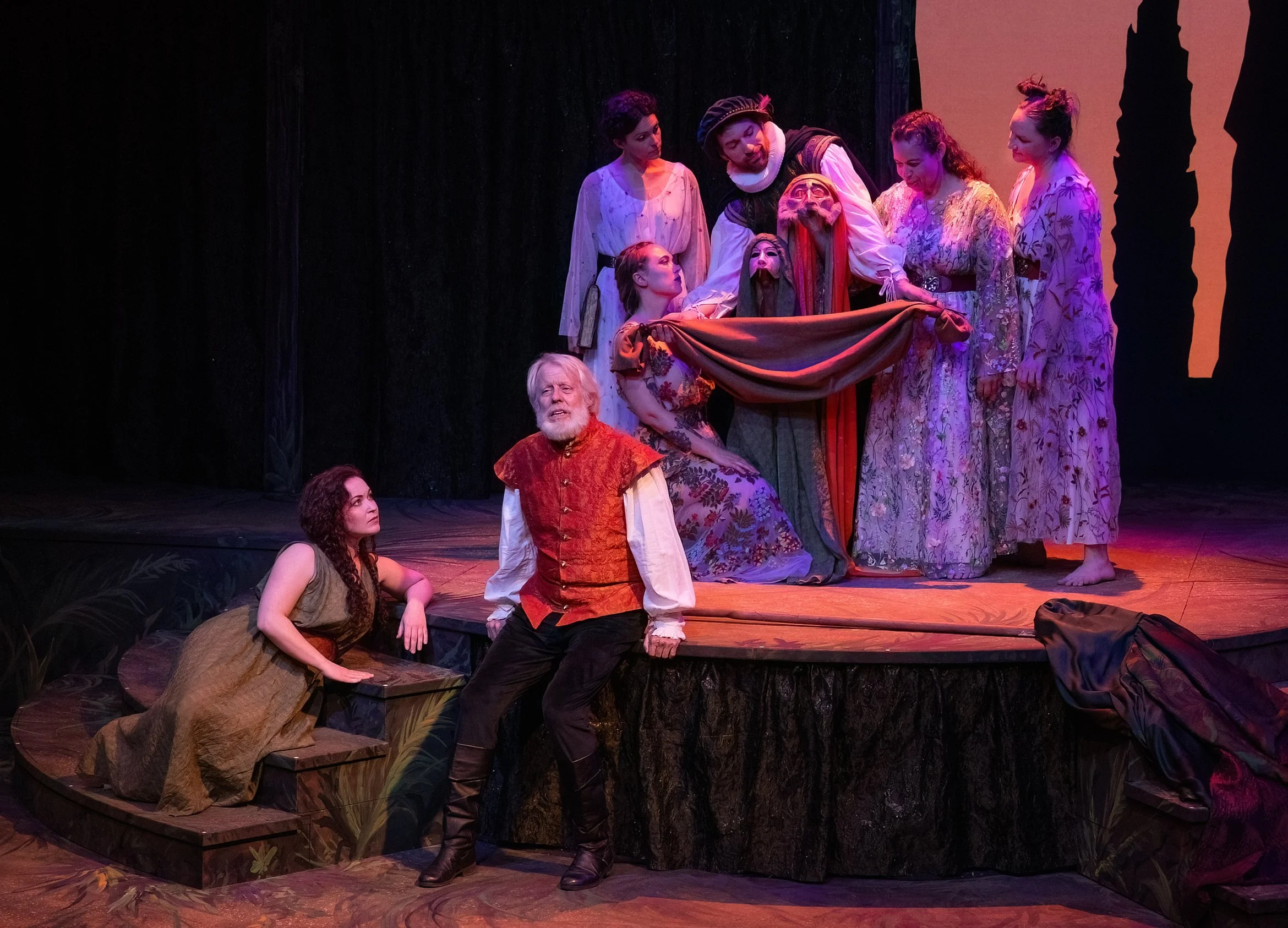 Bryn Booth as Miranda (left) listening to Joseph McGrath as Prospero (center) tell a tale of "sea sorrow" with an assist from his airy spirits. Photo by Tim Fuller ©2026
