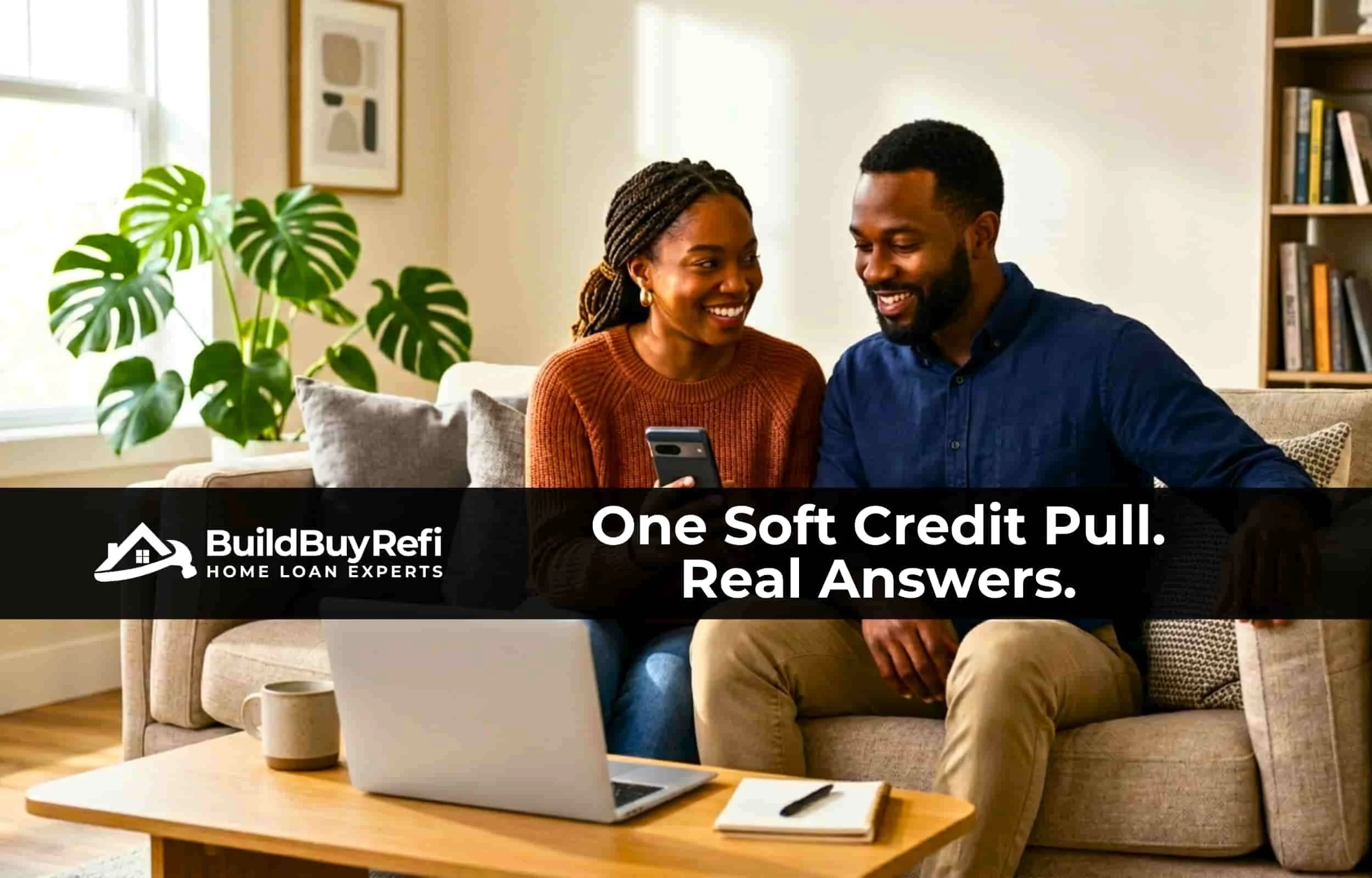 A black couple sitting on their couch with a laptop and notepad on a coffee table, a monstera plant in the background, they are smiling, looking at their phone after getting approved for Down Payment Assistance with BuildBuyRefi.com