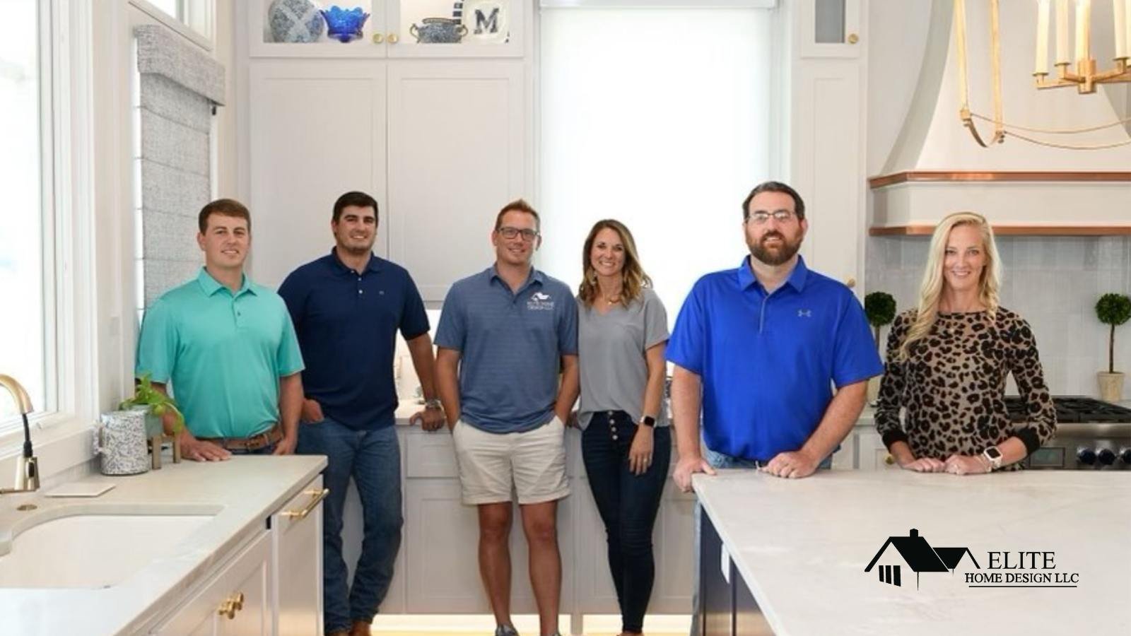 The Elite Home Design Team with Scotty Howard, Builder Owner, and his team standing in a brand new custom home kitchen.