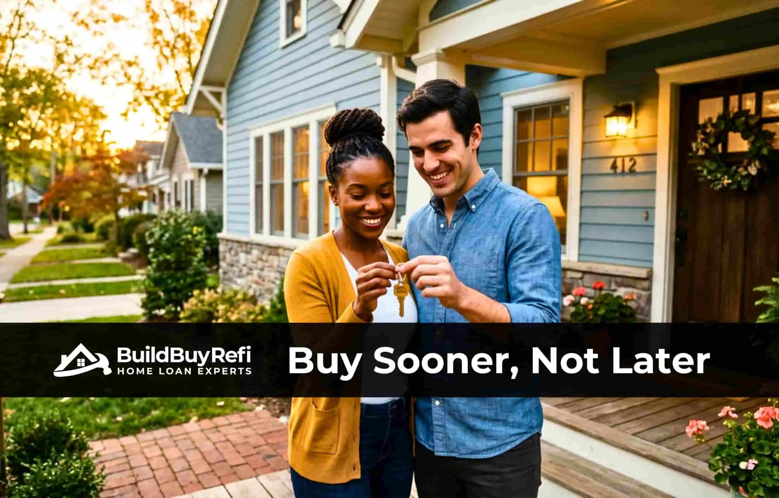 An interracial couple standing in their front bricked porch of their home, half stone and half blue siding, wood door, black woman in cardigan, man in blue jean shirt, holding keys after closing with BuildBuyRefi.com
