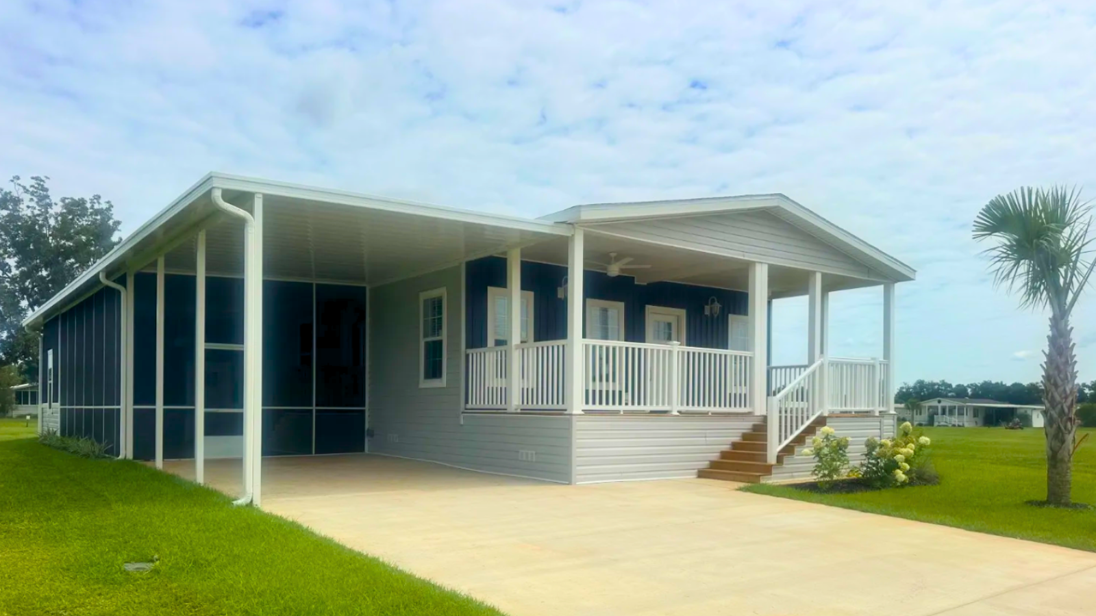 A Beautiful Florida Manufactured Home with Screened in Porch, Covered Deck with Ceiling fans, covered carport offered by Suncrest Homes and financed by BuildBuyRefi.com