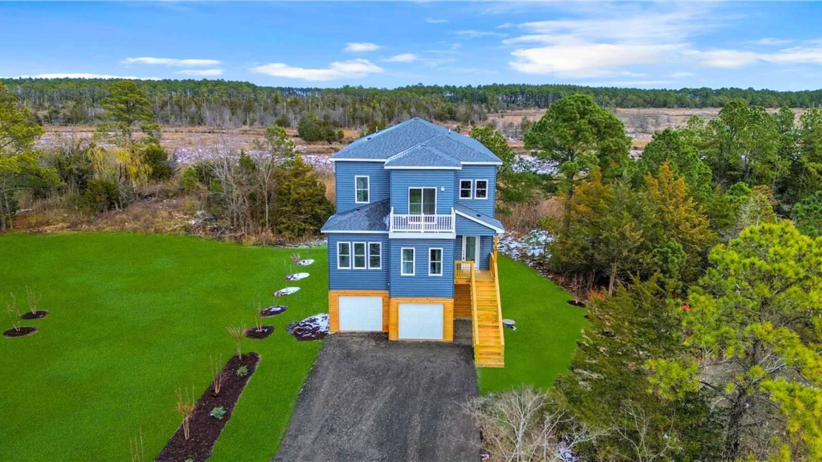 Beautiful 3 Level Custom Waterfront Home with blue siding, 2500 sq. ft. living space, 1350 sq ft. garage, custom decking and gables, beautiful lot, built by Almond Exteriors, a registered builder of BuildBuyRefi.com