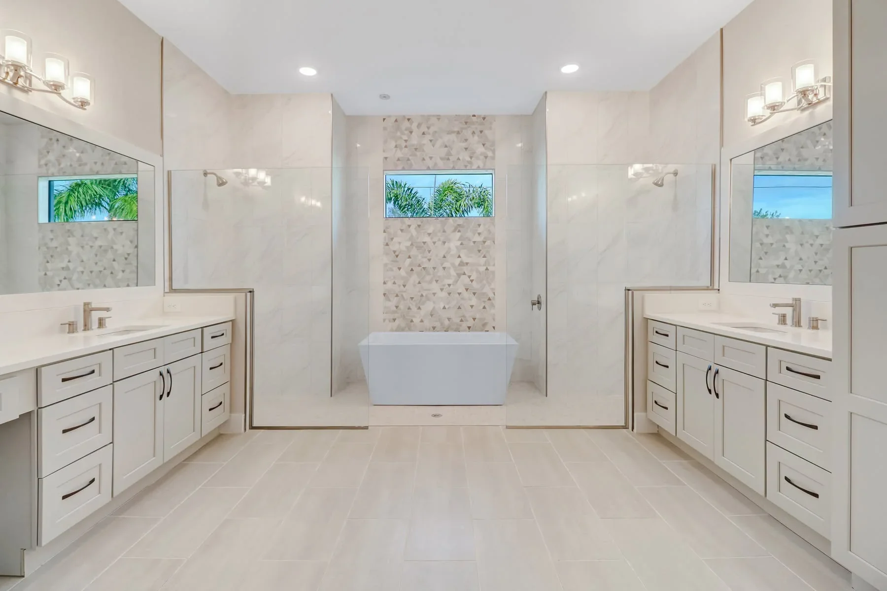 Luxury master bathroom, his and her sink, frameless wetroom shower with included bathtub, custom title work, marble, and cabinetry designed Sposen Signature Homes of Florida financed by BuildBuyRefi Home Loans.