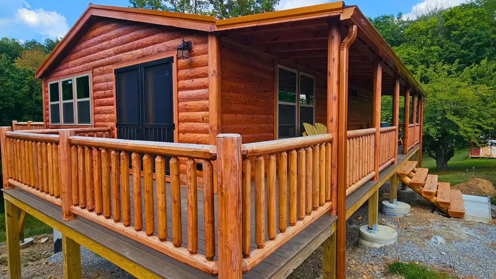 Beautiful Oak Log Redwood Cabin by Amish Built Cabins, one story on full basement, wrap around covered deck, porch on front and rear, up to 100% financing from BuildBuyRefi.com